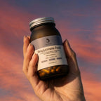 ELIVIDE magnesium bisglycinate supplement bottle held in hand at sunset